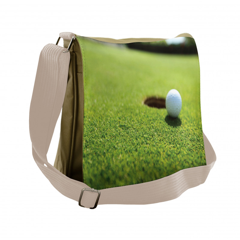 Golf Ball on Lip of Cup Grass Messenger Bag