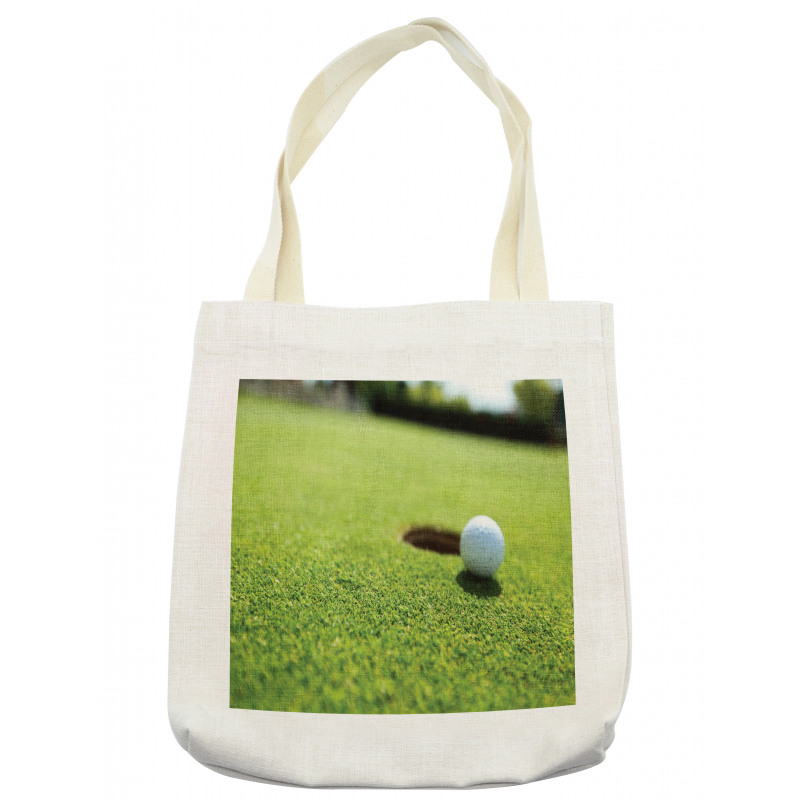 Golf Ball on Lip of Cup Grass Tote Bag